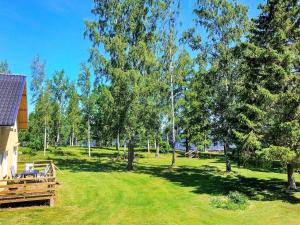 a view of a park with trees and a house at 14 person holiday home in HOVA-By Traum in Hova +45 photos