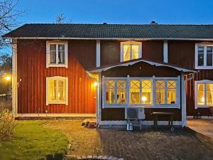 een groot rood huis met veel ramen bij Idyllic Family Retreat Close to the Sea in Ronneby