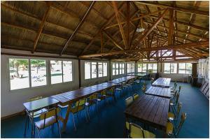 a large room with tables and chairs and windows at Hotel Radio in Valle Hermoso