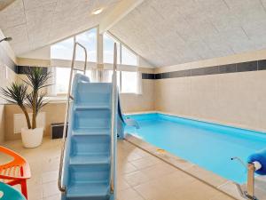 a swimming pool with an slide in a room at 5 star holiday home in Bogense in Bogense
