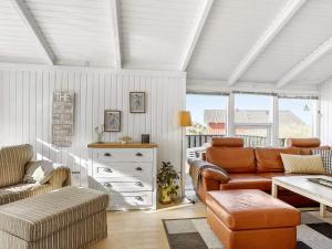 a living room with a couch and a table at 4 star holiday home in Hjørring in Kærsgård Strand