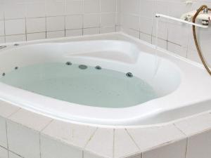a bath tub filled with blue water in a bathroom at 8 person holiday home in Hjørring-By Traum in Kærsgård Strand