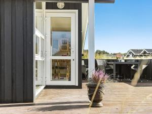an open door to a patio with a table at 8 person holiday home in Hjørring-By Traum in Kærsgård Strand