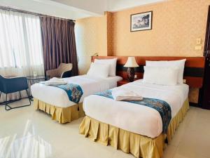 Katil atau katil-katil dalam bilik di Sirimathani Hotel