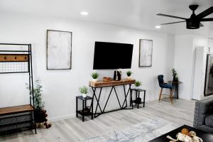 a living room with a flat screen tv on a wall at Escape in Bastrop in Bastrop