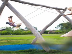 a person jumping in the air over a river at Chalet in Friesland near Alde Feanen Park in De Veenhoop +14 photos