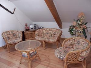 a living room with two chairs and a table at Holiday Home in Vosges with Garden and BBQ in Le Haut-du-Them +32 photos