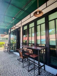 a group of tables and chairs on a patio at Lay Sea and Beach Hotel in Phetchaburi