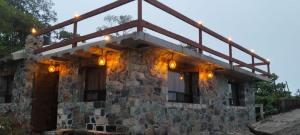 a stone house with lights on top of it at Nasaka jacala in Cuetzalán del Progreso