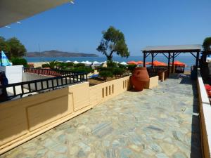 a resort with a view of the beach and the ocean at Camelia Studios & Apartments in Stalos