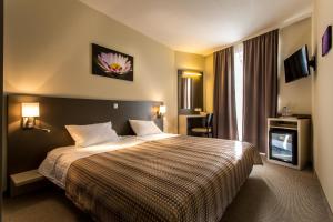 a hotel room with a bed and a television at Corvin Hotel Budapest Corvin Wing in Budapest