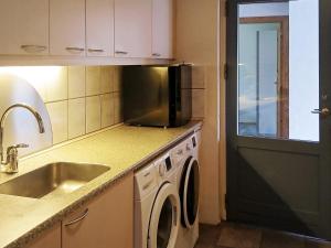 a kitchen with a sink and a washing machine at 12 person holiday home in Hojslev-By Traum in Bøstrup