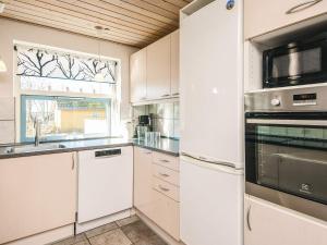 a kitchen with white cabinets and a window at 12 person holiday home in Hojslev-By Traum in Bøstrup
