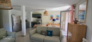 a living room with a couch and a kitchen at New house with all comforts in Grimaud in Grimaud