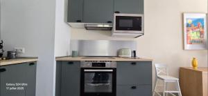 a kitchen with a stove and a microwave at New house with all comforts in Grimaud in Grimaud +24 photos