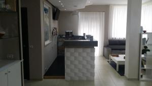a kitchen and living room with a counter in the middle at B&B MIRAGE in Bari