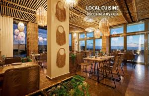 a restaurant with tables and chairs and chandeliers at Miramare Magnetic Beach Hotel in Kobuleti +22 photos