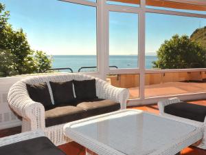 a living room with a couch and a table at Dom Pedro Madeira in Machico