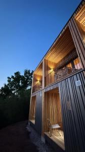 a building with a bench sitting inside of it at Feinzeit Naturloft - Klima, Sauna, Design in Frensdorf +12 photos