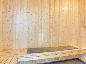 a bench in a sauna with a wooden wall at 5 star holiday home in Bogense in Bogense