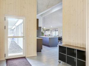 a large room with a kitchen and an open door at 5 star holiday home in Bogense in Bogense +34 photos