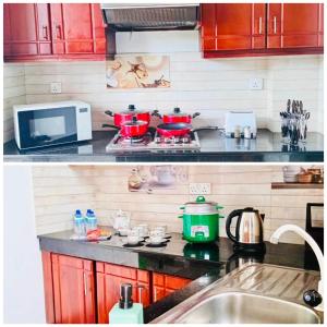 a kitchen with a counter top with red pots and pans at Westin Villa in Wattala