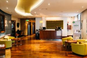 a lobby with a bar and tables and chairs at Kilkenny Pembroke Hotel in Kilkenny