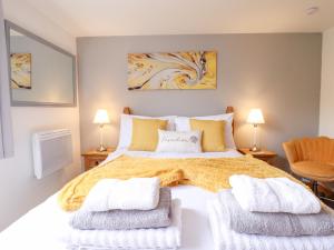 a bedroom with a large bed with two lamps at Angel's Retreat in Alford