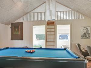 a pool table in a living room with a pool at 14 person holiday home in Vejby in Vejby +46 photos