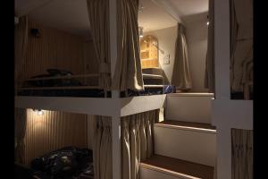 a bedroom with a bunk bed and a room with a bed at Iloilo Condo for Group Stay in Iloilo City +17 photos
