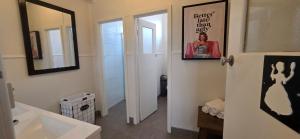 a bathroom with a white sink and a mirror at The Corner Hotel Alexandra in Alexandra