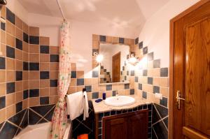 a bathroom with a sink and a tub and a mirror at Casa Danilo in San Teodoro +35 photos