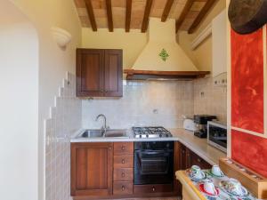 a kitchen with a sink and a stove at Getaway in the Sibillini Hills in Monte San Martino