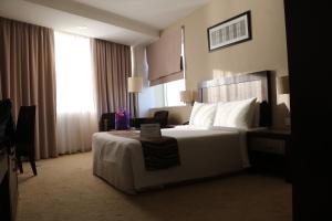 Postel nebo postele na pokoji v ubytování Hotel Felda Residence Kuala Terengganu