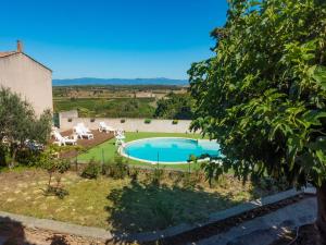 an external view of a villa with a swimming pool at Holiday Home in Montbrun with Pool & Vineyards in Montbrun-des-Corbières