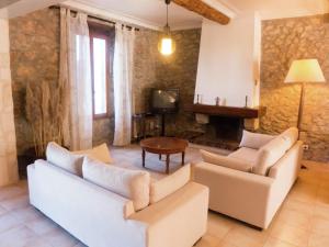a living room with two white couches and a tv at Holiday Home in Montbrun with Pool & Vineyards in Montbrun-des-Corbières +32 photos