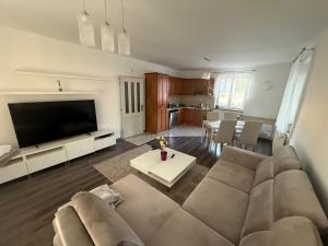 a living room with a large couch and a table at Samaria Apartments in Šamorín