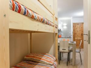 a bunk bed in a small room with a table at Apartment Cervinia ski-in ski-out slopes in Breuil