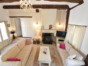 a living room with a couch and a fireplace at Luxury Villa in Dordogne with Pool & Privacy in Port-Sainte-Foy-et-Ponchapt
