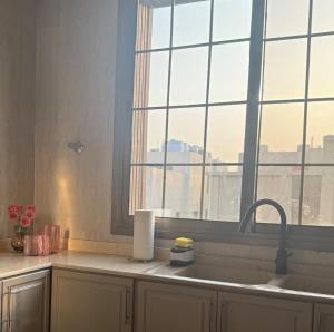 a kitchen with a sink and a window at Malath - The Bohemian Haven in Dammam +20 photos