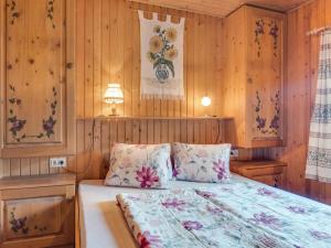 a bedroom with a bed with wood paneled walls at Chalet in Mörtschach near Ski Slopes in Mörtschach +26 photos