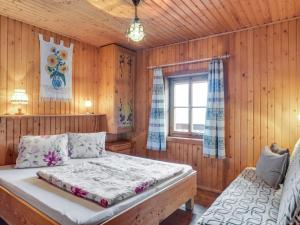 a bedroom with a bed and a window at Chalet in Mörtschach near Ski Slopes in Mörtschach
