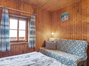 a living room with a couch and a window at Chalet in Mörtschach near Ski Slopes in Mörtschach