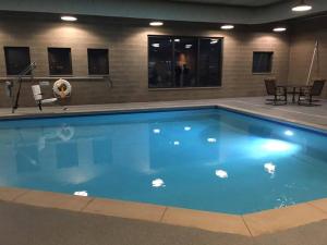 a swimming pool with blue water in a building at Pier B Resort in Duluth