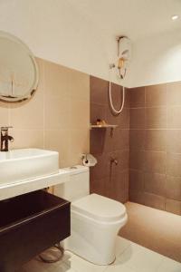 a bathroom with a toilet and a sink at Keep Diving Resort Bohol in Panglao