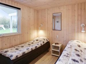 a bedroom with two beds and a window at 5 star holiday home in Idestrup in Bøtø By
