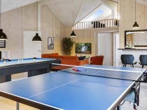 a ping pong room with two ping pong tables at 5 star holiday home in Idestrup in Bøtø By