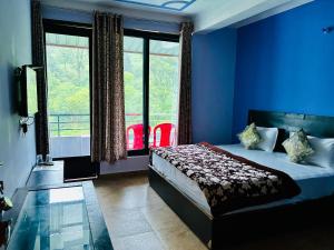 a blue bedroom with a bed and a window at Green Valley Hotel in Lansdowne