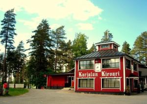 a red building with the words australian architect on it at Karjalan Kievari in Kesälahti