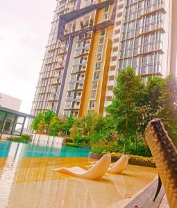 two wooden objects in the water in front of a building at NearEcobotanic & Legoland-HappyMoonlight-2B2R-8px in Iskandar Puteri